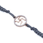 Swastik Rakhi with Accents in Rose Gold Finish on Grey Cord Swastik Rakhi with Accents in Rose Gold Finish on Grey Cord